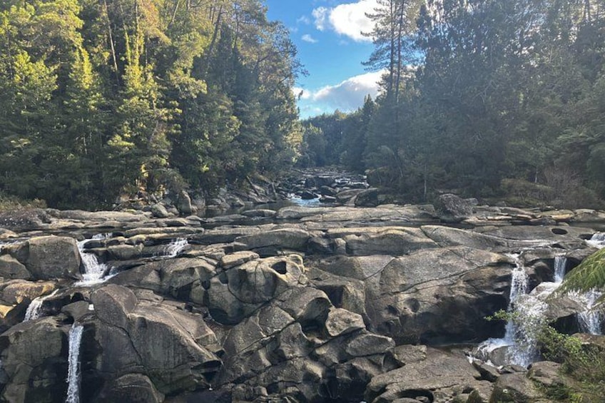 A rocky landscape with multiple waterfalls. 1