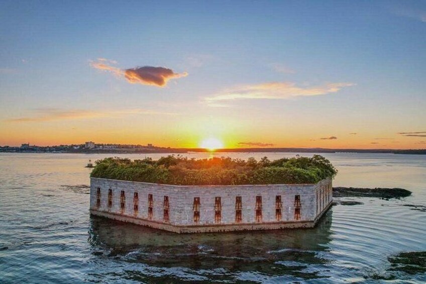 A waterfront structure with a garden on top, surrounded by water. 2