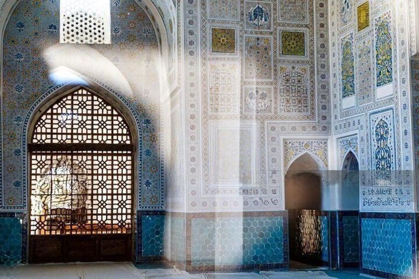 An interior with arched doorways, intricate tile patterns, and a decorative screen. 5