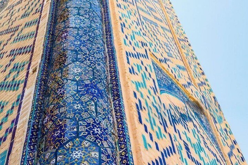 A tall building with intricate blue and beige patterned designs. 4