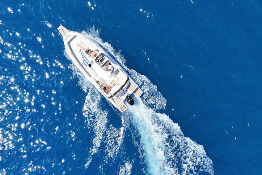 A speedboat creating a wake in the ocean. 3