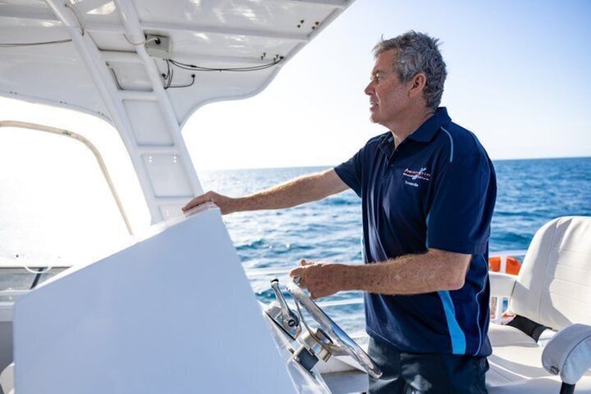 A person steering a boat on the water. 3
