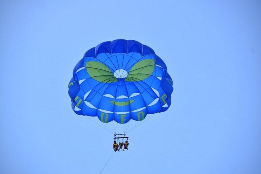 A blue parachute with green accents and the word 'CLOUD' on it, attached to a cable system. 1