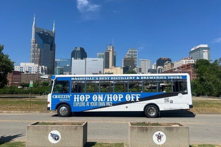A bus with 'Nashville's Best Distillery & Breweries Tours' and 'Hop On/Hop Off' text. 1