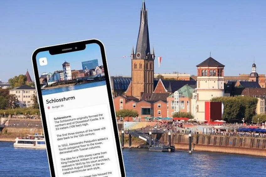 Un smartphone affiche des informations sur le Schlossturm, une tour historique située dans une ville européenne, avec une rivière en arrière-plan. 5