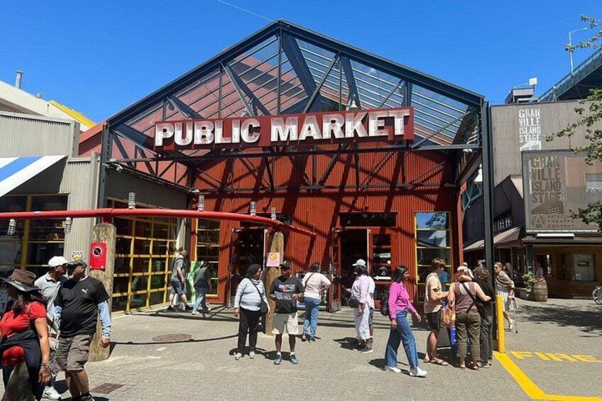 A public market with a red metal structure and a glass entrance. 4