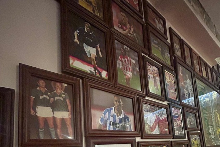 A wall of framed sports photographs. 2
