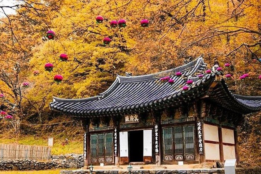 A traditional Japanese building with a tiled roof and a wooden structure. 4