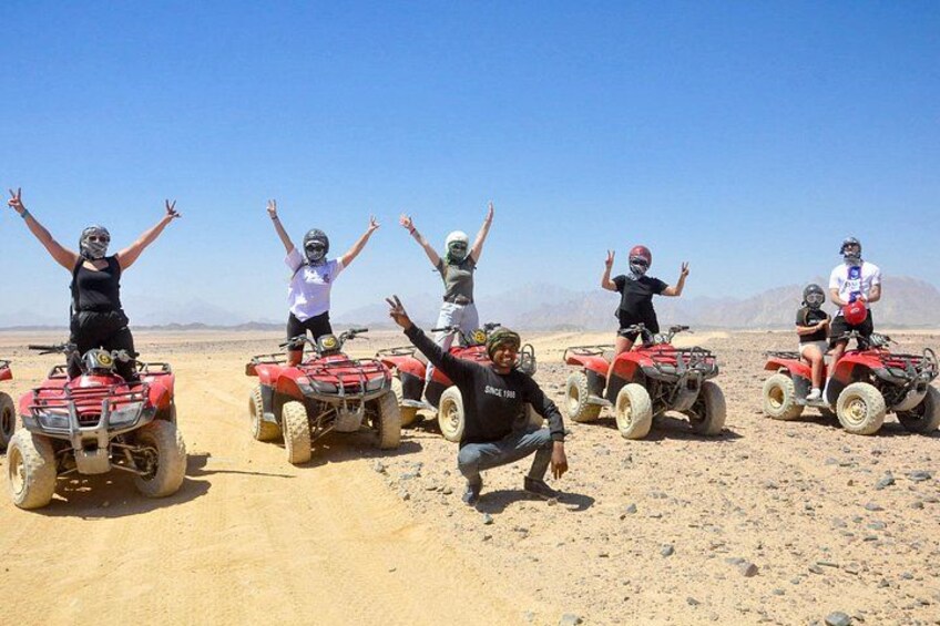 A group of people on ATVs in a desert landscape. 5
