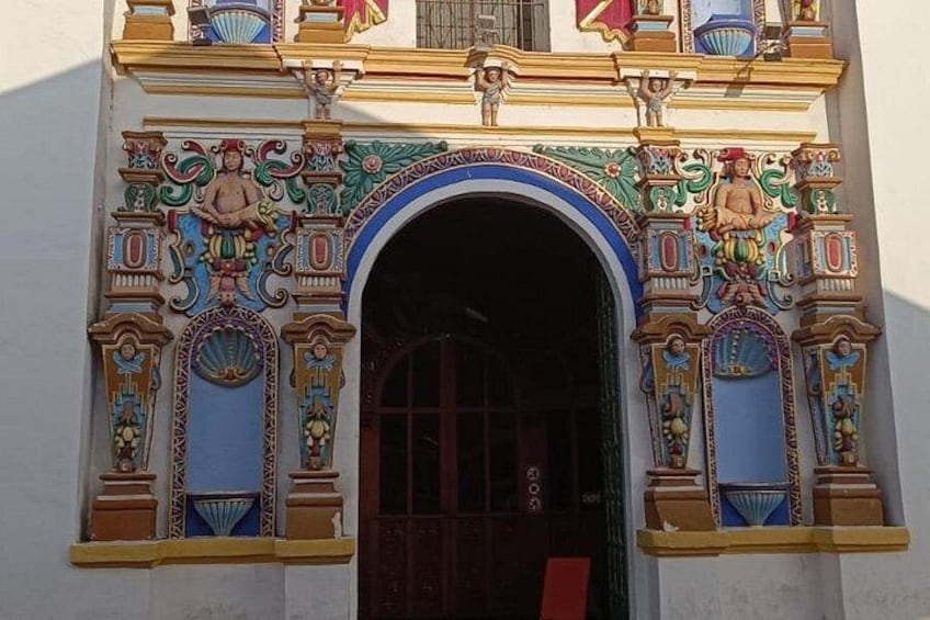 A building facade with ornate architectural details, including a central archway and decorative elements. 4