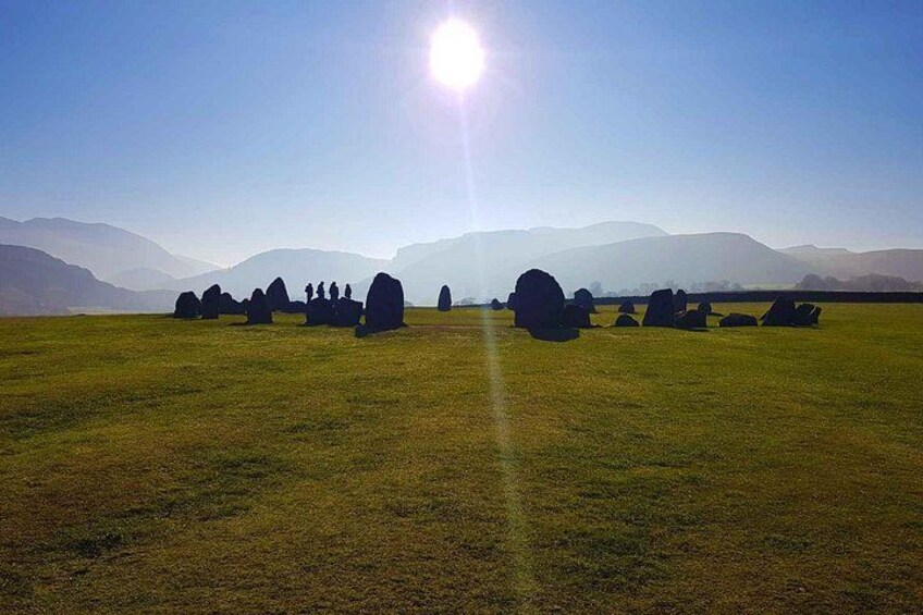 A field with standing stones under a clear sky. 4