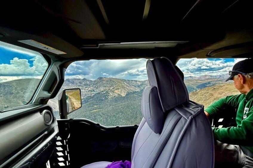 A car interior with a mountainous landscape visible through the windshield. 5