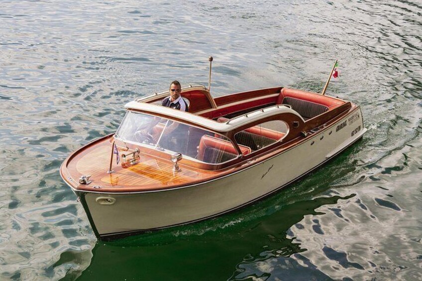 A classic wooden motorboat on calm water. 5