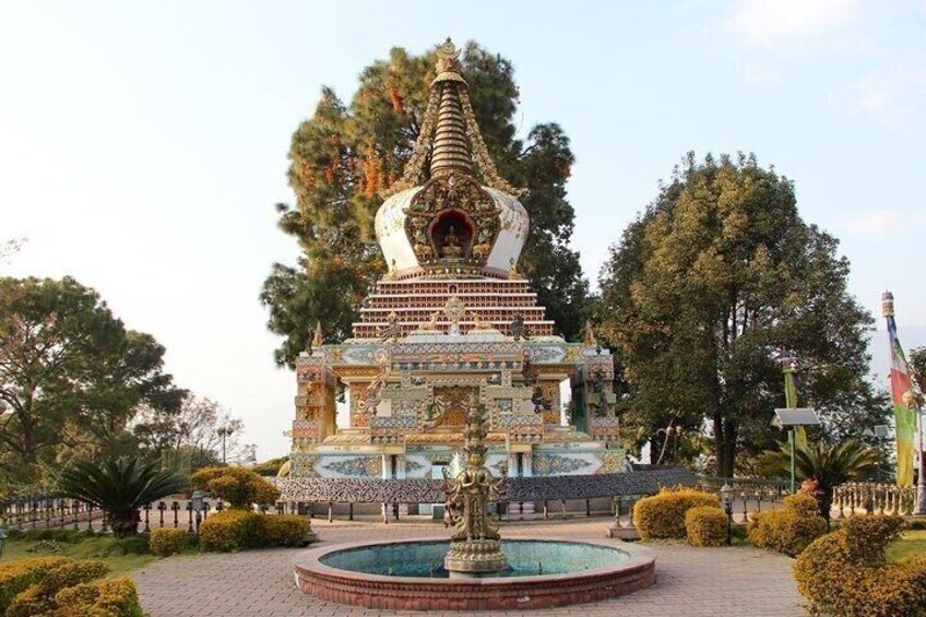 A multi-tiered pagoda with intricate designs, a central fountain, and a well-maintained garden. 3