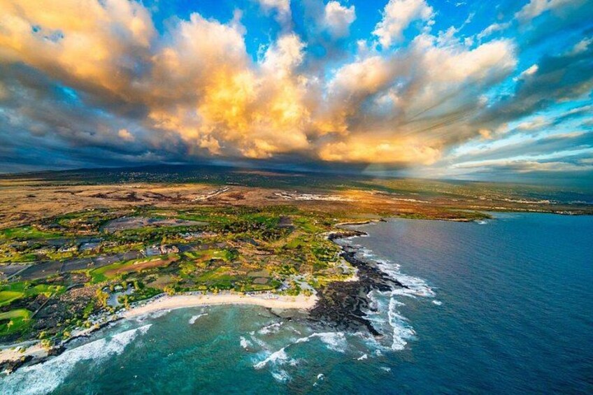 A coastal landscape with a beach, ocean, and a distant city skyline. 2