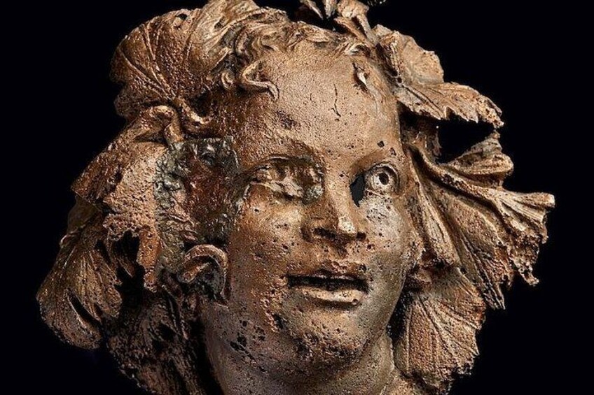 A sculpture with intricate leaf patterns and a rough texture. 4