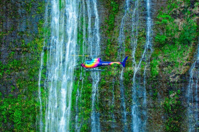 A helicopter flying over a waterfall. 5