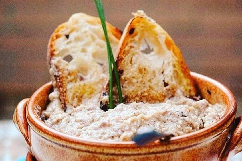 A bowl of food with two pieces of bread on top. 4