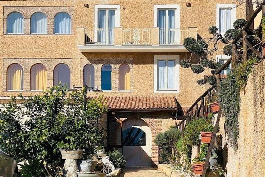 A two-story building with arched windows and a tiled roof. 5