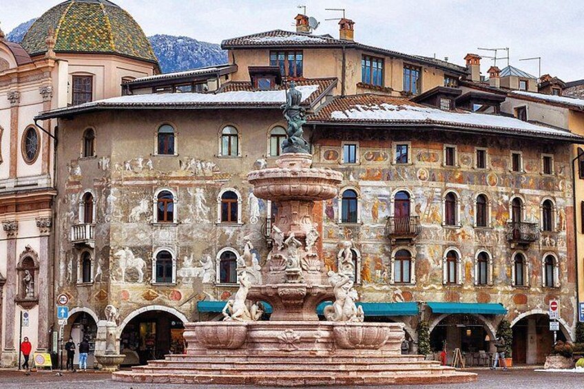 A historic building with a fountain, statues, and a dome. 4