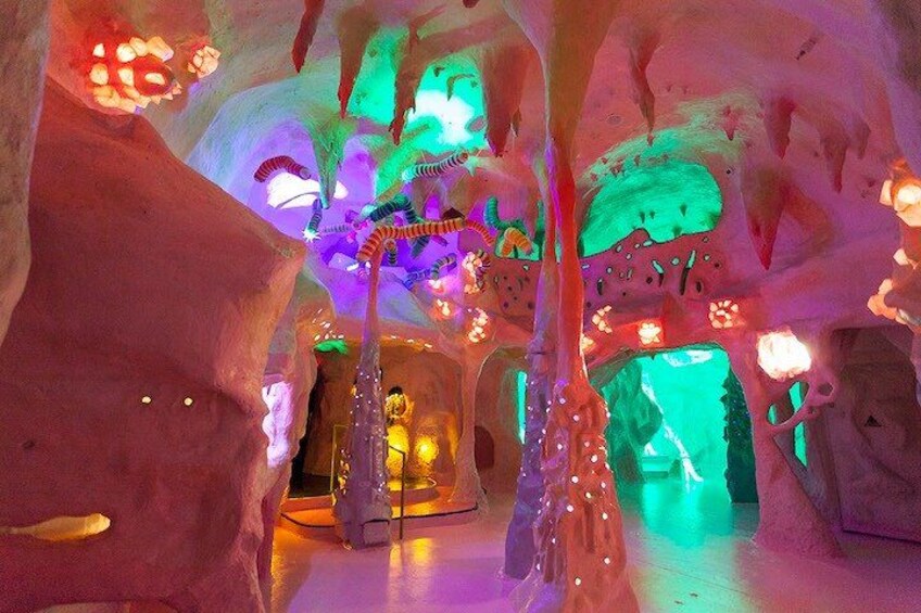 An ice cave with colorful lighting and sculptures. 3