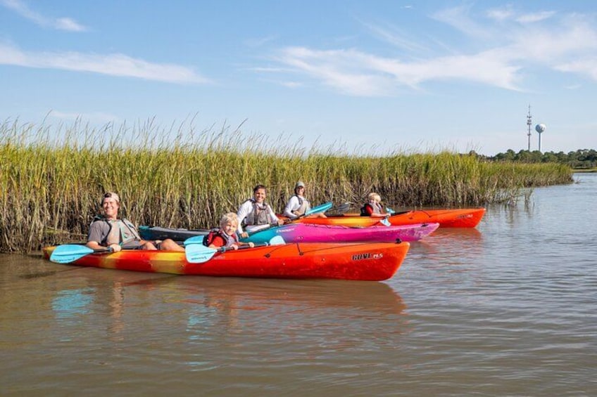 People in colorful kayaks on a calm river. 4