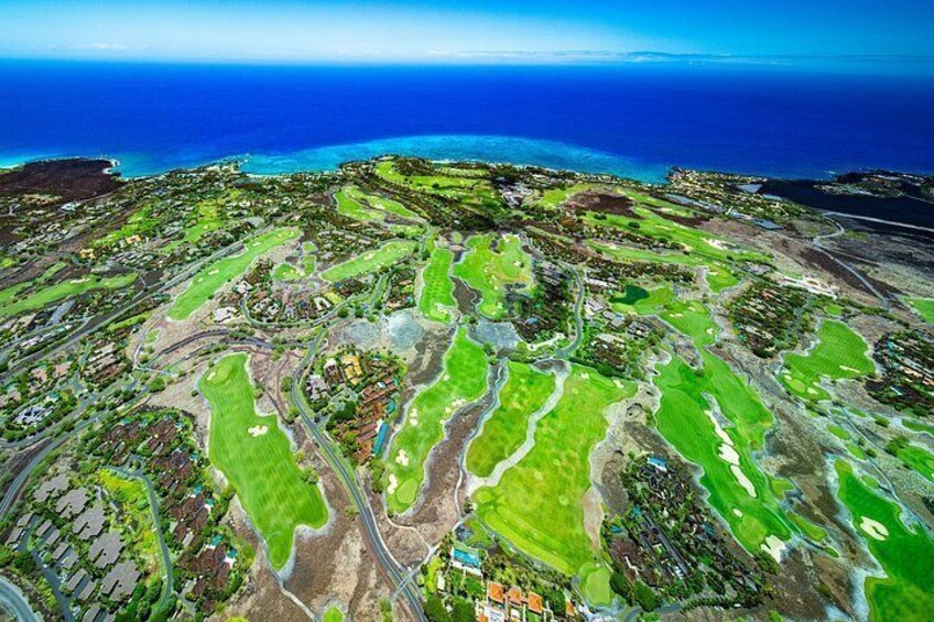 Glide over famous courses encircled by the rugged flow of Hualālai’s volcano 2