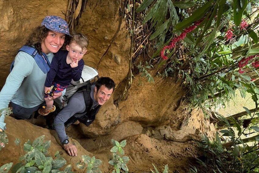 A family climbing a rocky terrain with vegetation around. 3
