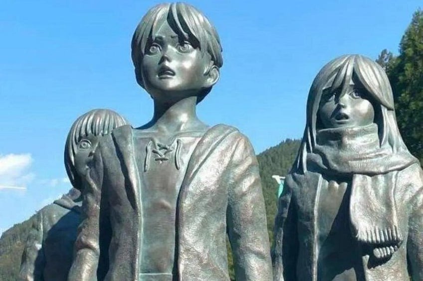 A statue of two figures, one with a scarf and the other with a jacket. 2
