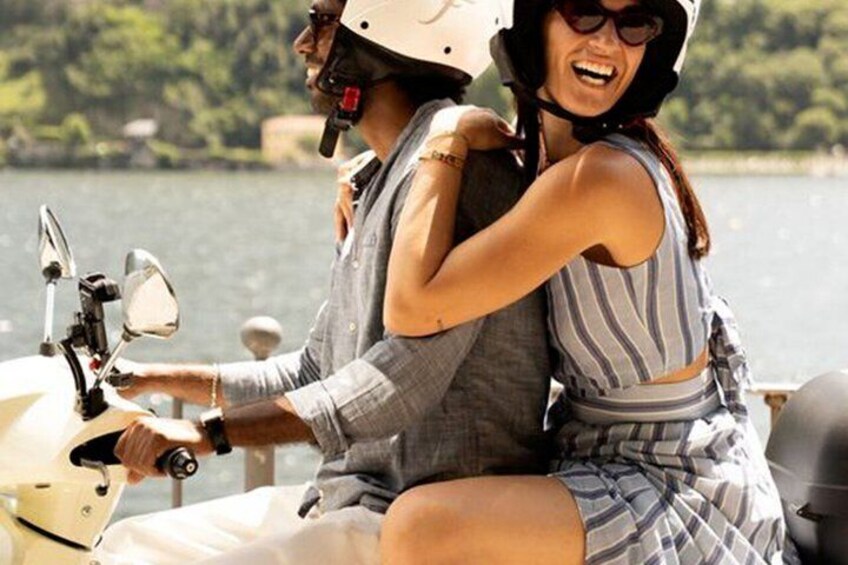 Two people on a boat, one driving, the other sitting. 4