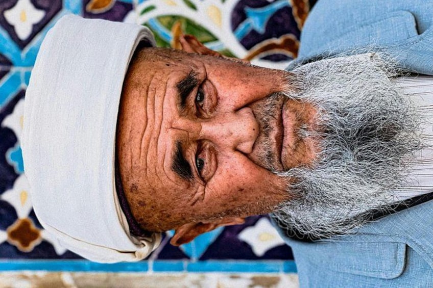 A person wearing a white cap and a blue shirt. 4