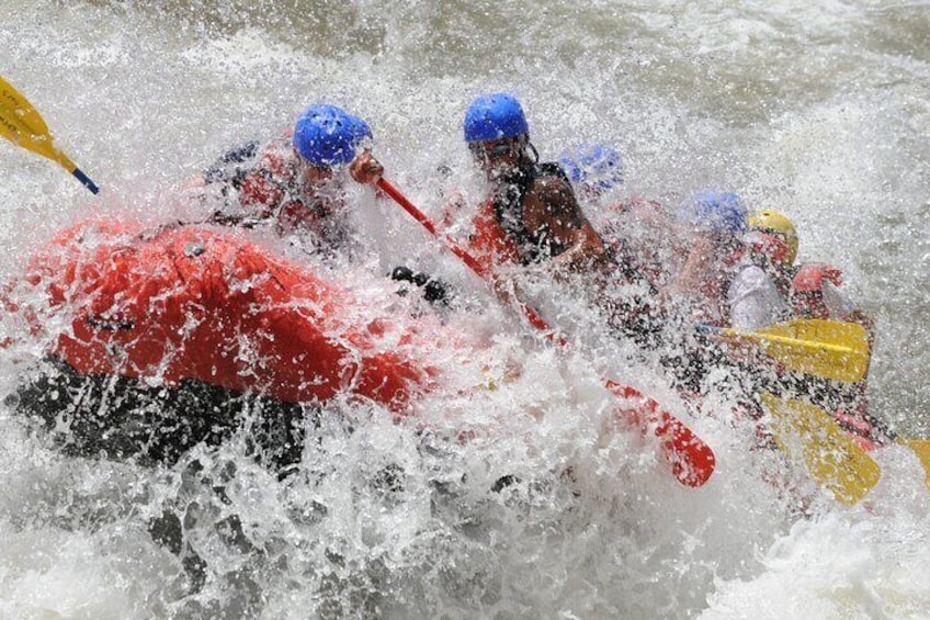 People in kayaks navigating through rough water. 2
