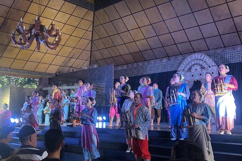 A group of people on a stage with a decorative backdrop and a chandelier. 5