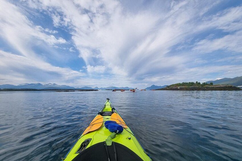 A kayak on calm water with a clear sky and distant mountains. 1