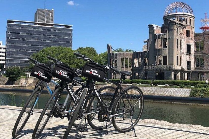 Biking by the iconic Atomic Bomb Dome in Hiroshima's Peace Memorial Park. 4