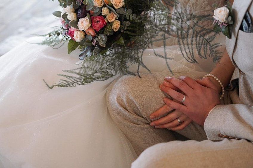 A person in a wedding dress holding a bouquet of flowers. 4