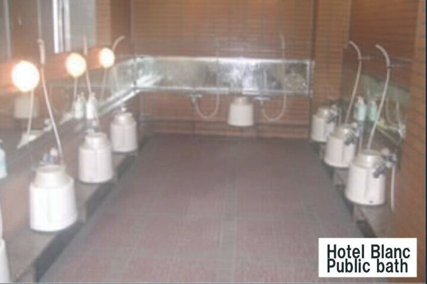 A public bath with multiple sinks and mirrors, labeled 'Hotel Blanc.' 2