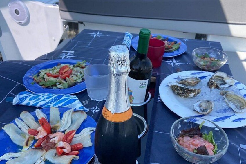 A table with food, a bottle of wine, and a glass of water. 2