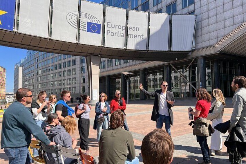 A group of people gathered in front of the European Parliament building. 1