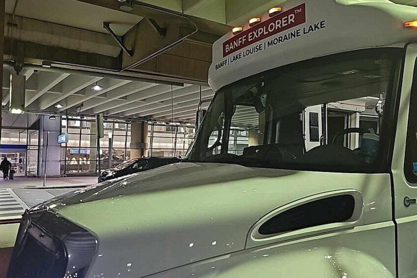 A bus with 'BANFF EXPLORER' and 'MORAINE LAKE' written on it. 4