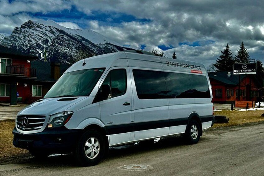 A white van parked in front of a building with a sign that reads 'Northwinds.' 5