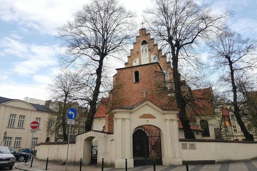 A church with a red roof and a white facade, a no entry sign, and bare trees. 2