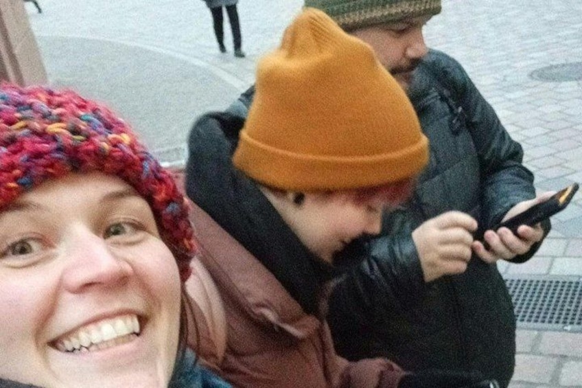 A person wearing a yellow beanie and a black jacket. 5