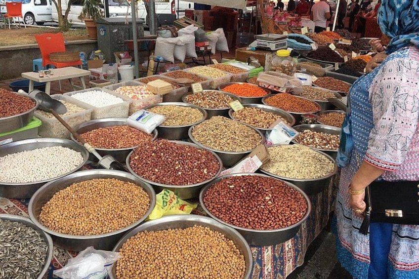 Un mercato con grandi ceste di diversi tipi di legumi e lenticchie. 3