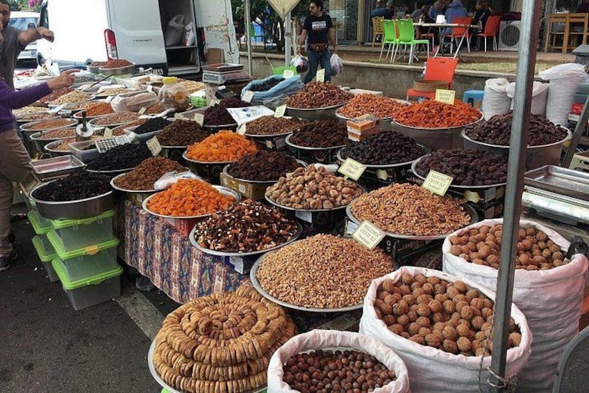 A market with various bins and sacks of nuts and dried fruits. 2