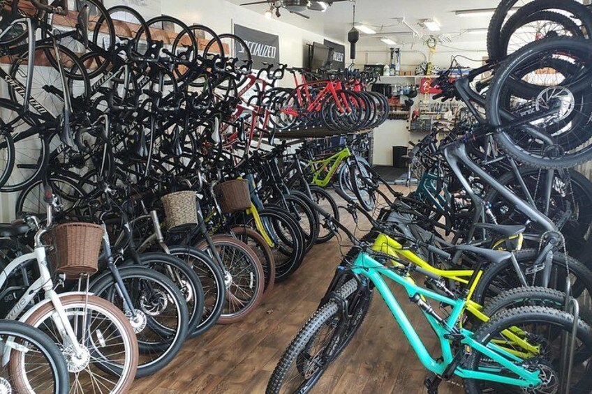 A bicycle shop with rows of bicycles and wheels on display. 4