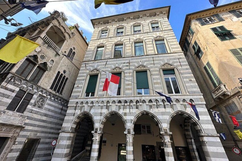 A historic building with arched windows and a central entrance. 2