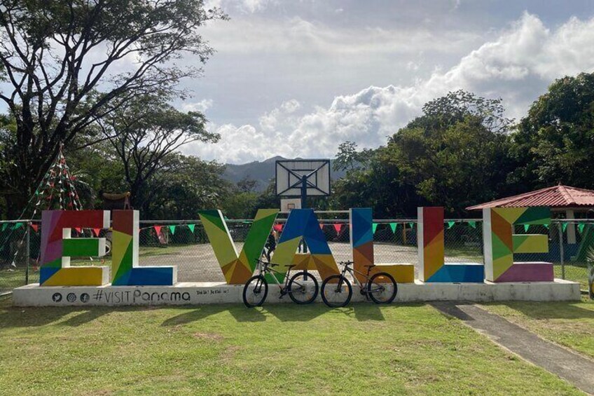 A colorful sign with the word "EVALVE" and a bicycle parked in front. 2