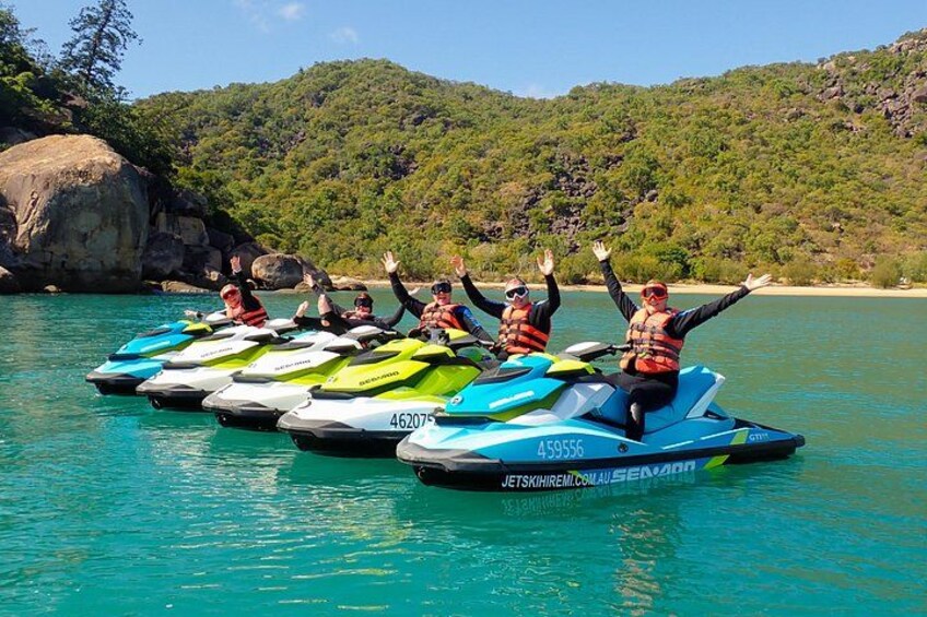 Jet skis on water with people wearing life jackets. 3