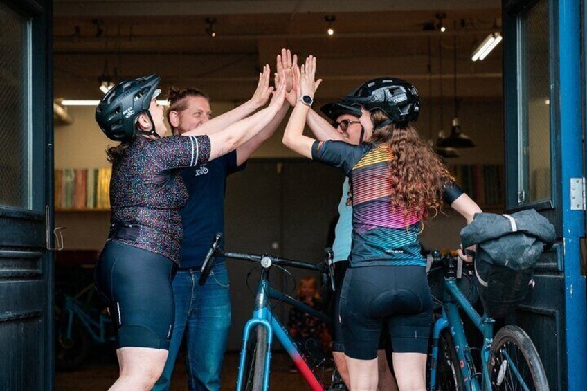 Four people giving a high-five. 4